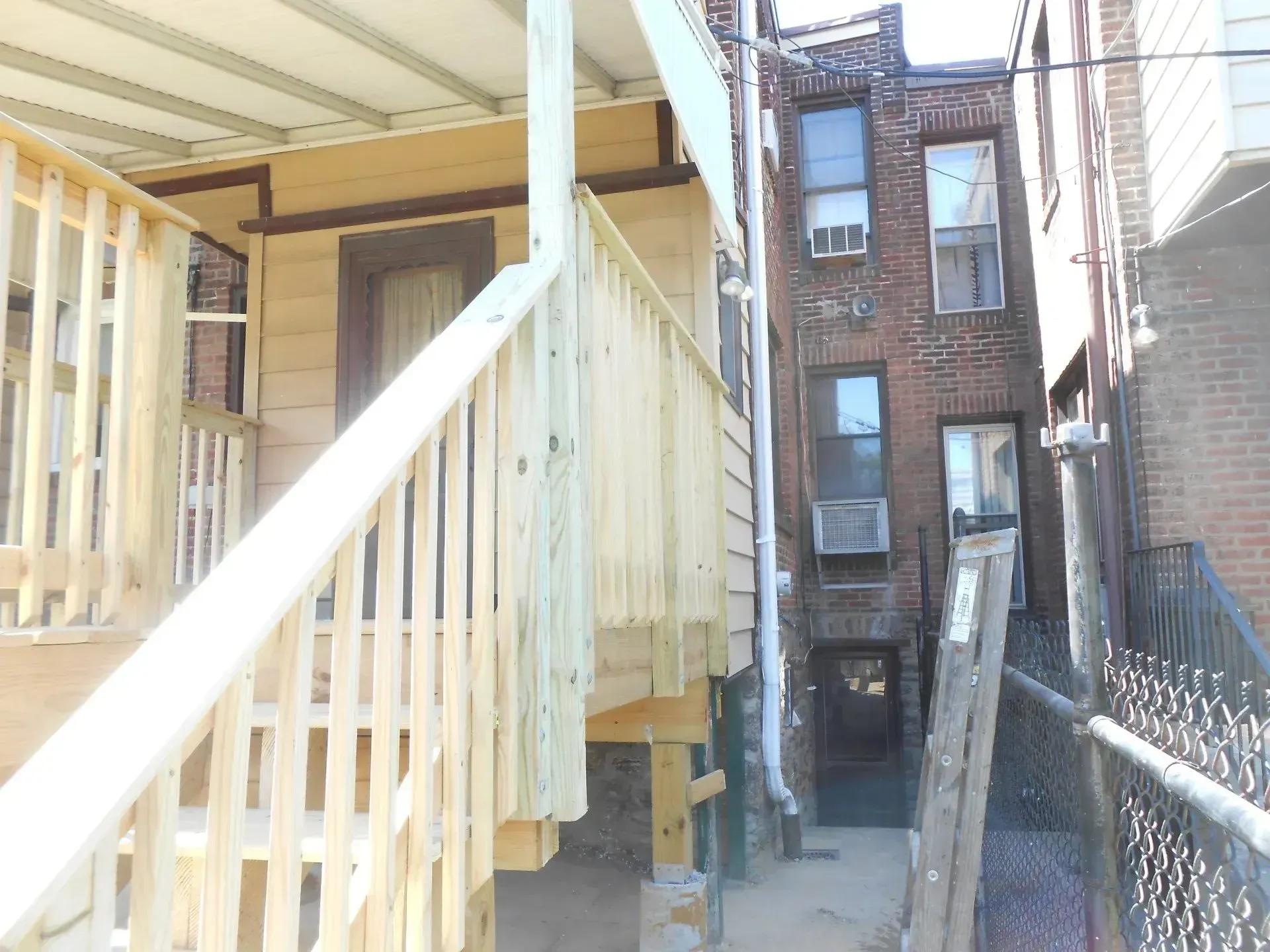 A wooden staircase leading up to a brick building
