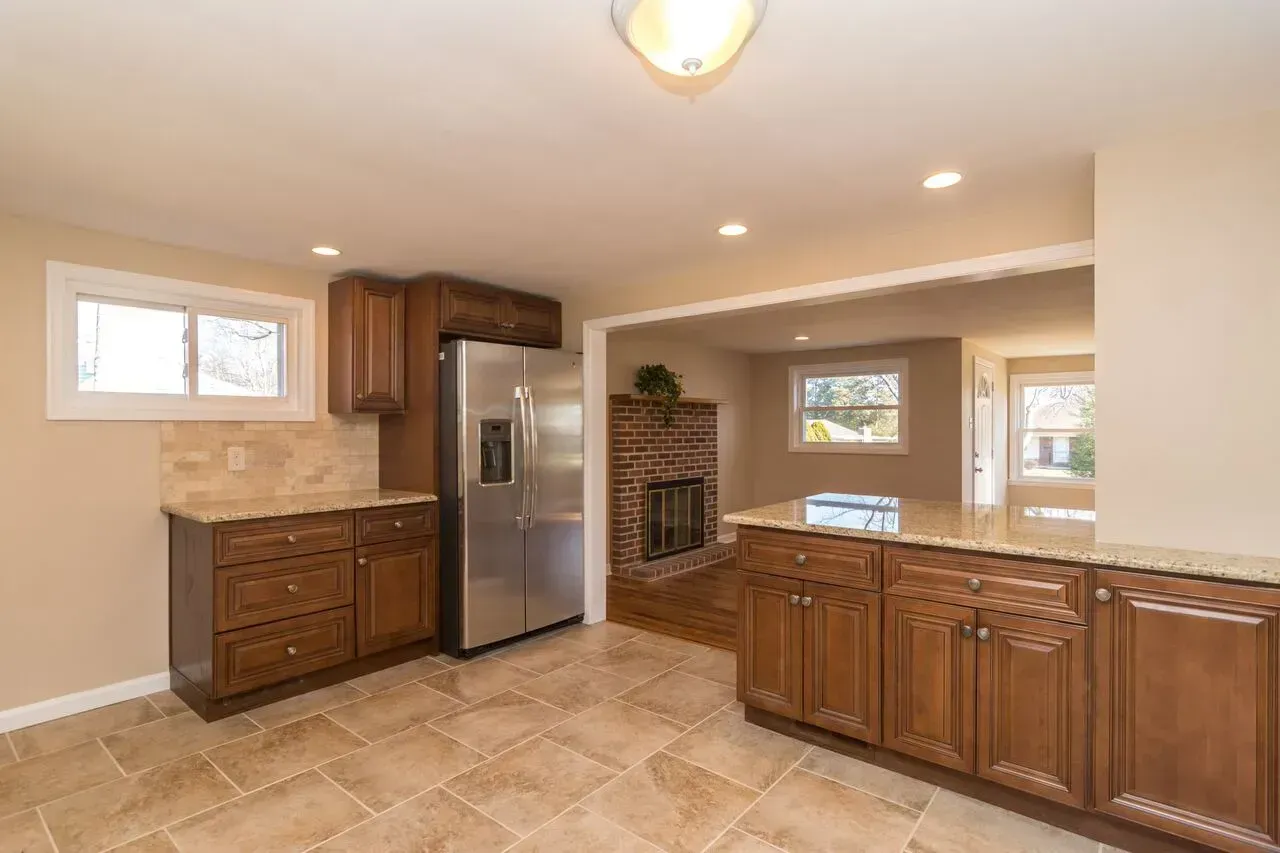 A kitchen with stainless steel appliances and wooden cabinets.