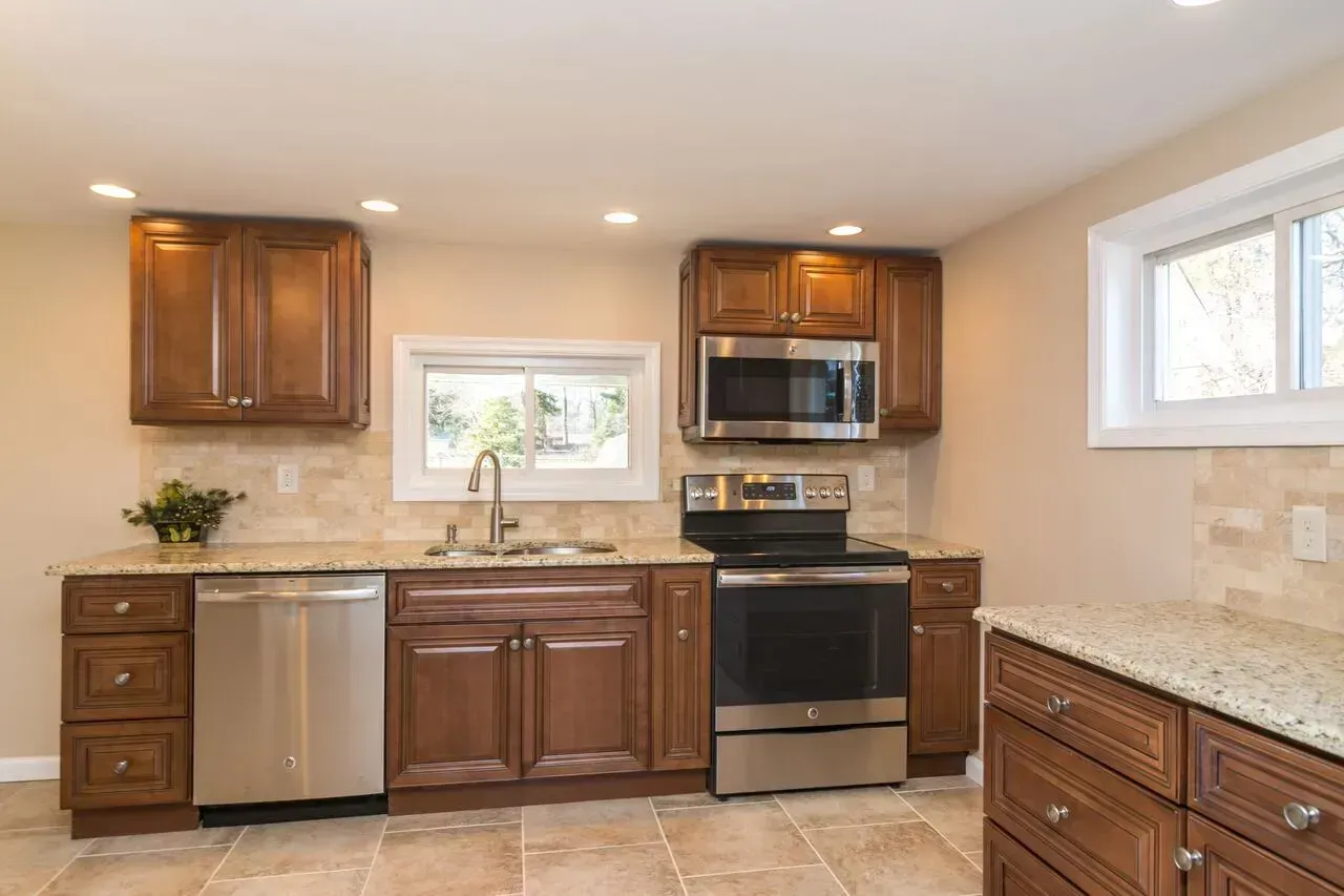 A kitchen with stainless steel appliances and wooden cabinets