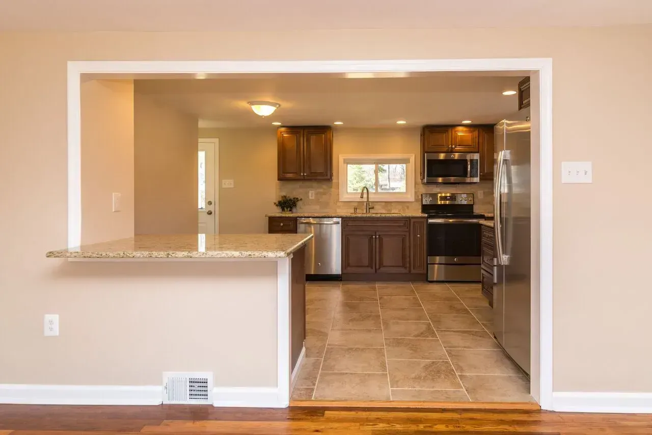 A kitchen with stainless steel appliances and granite counter tops.