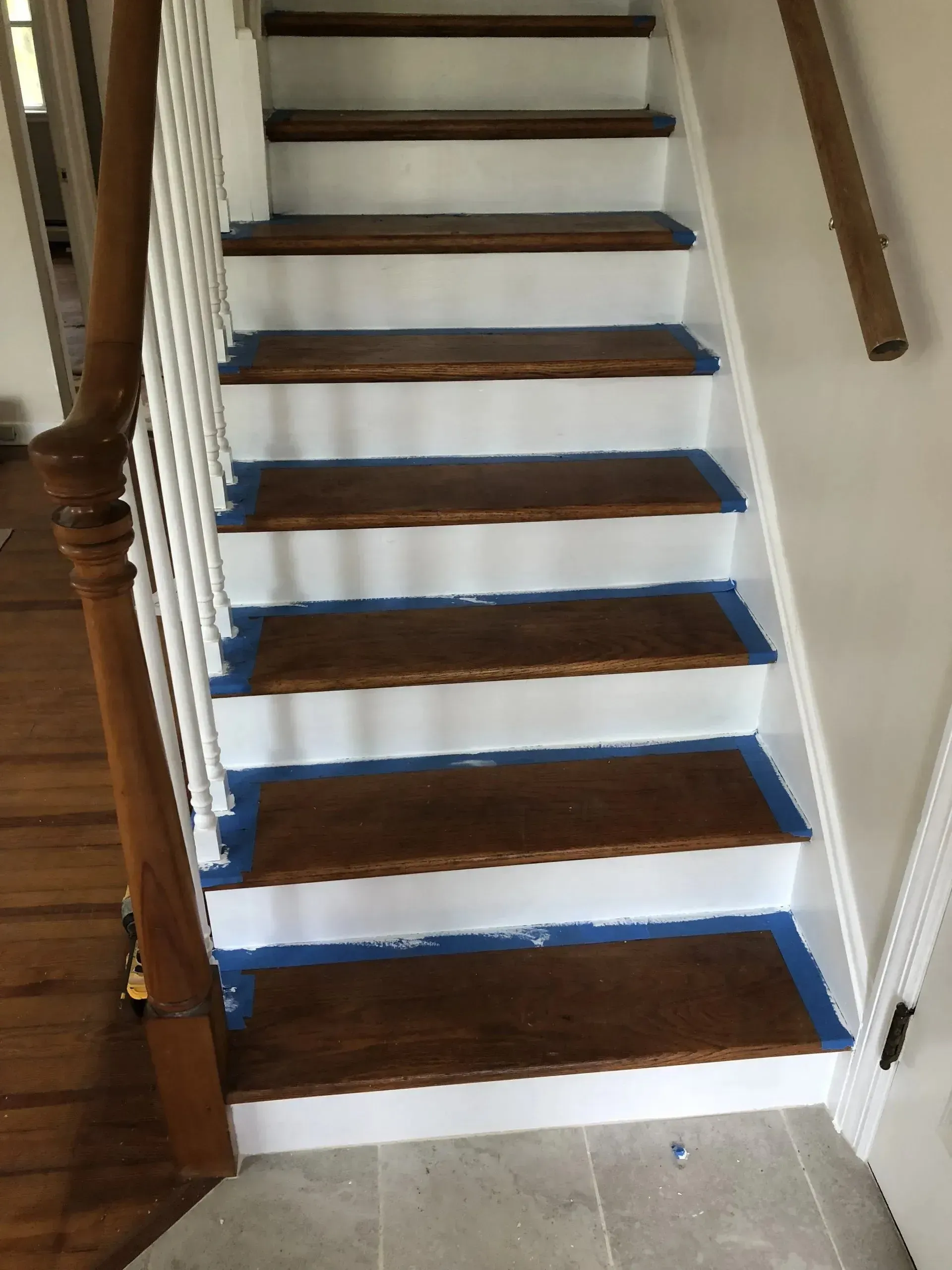 A set of stairs with blue tape on the steps