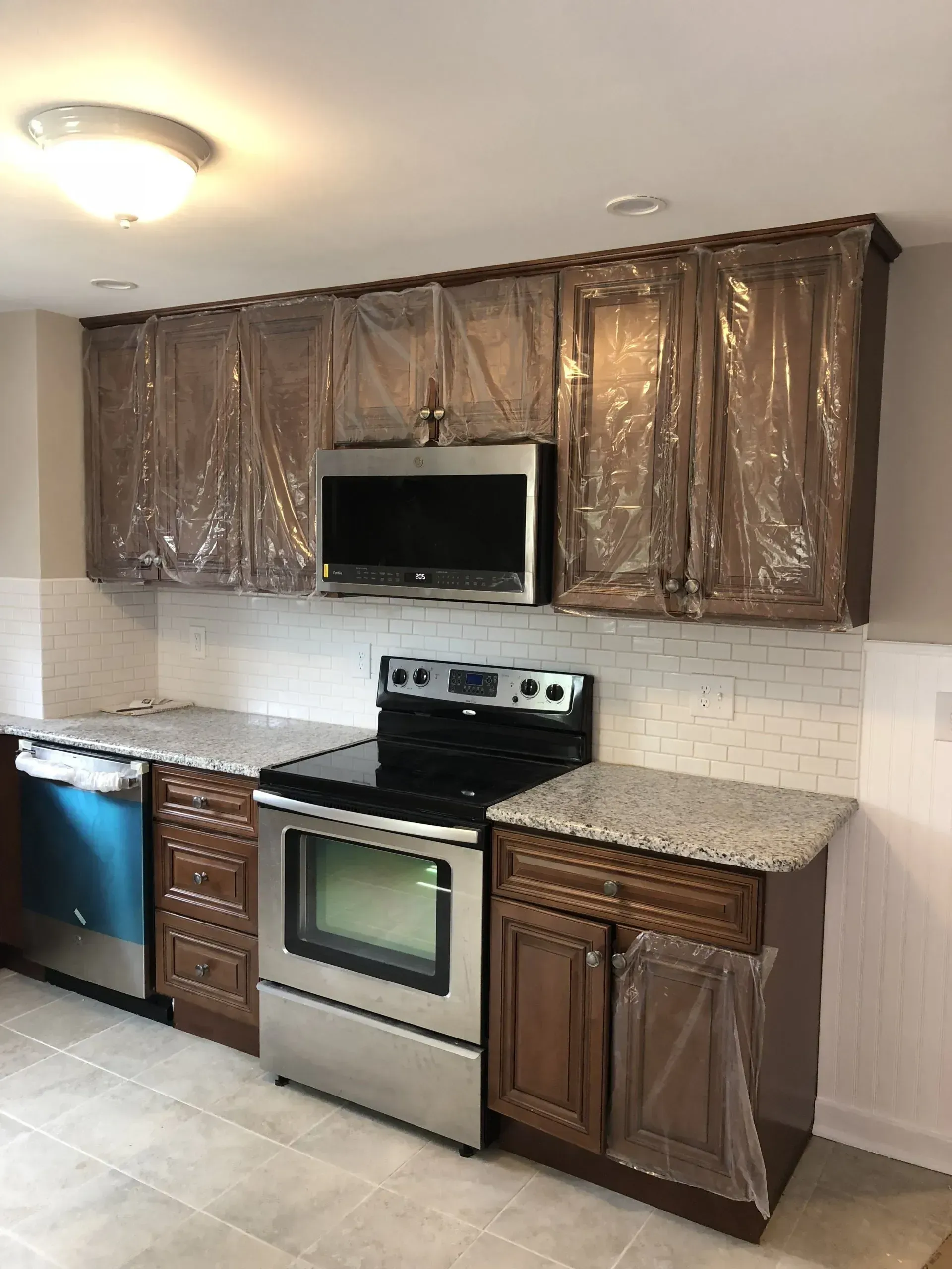 A kitchen with stainless steel appliances and wooden cabinets