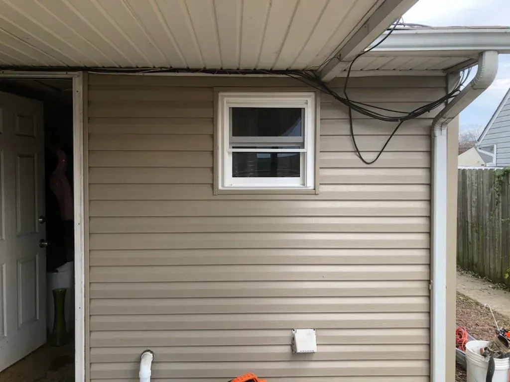 A house with a window on the side of it.