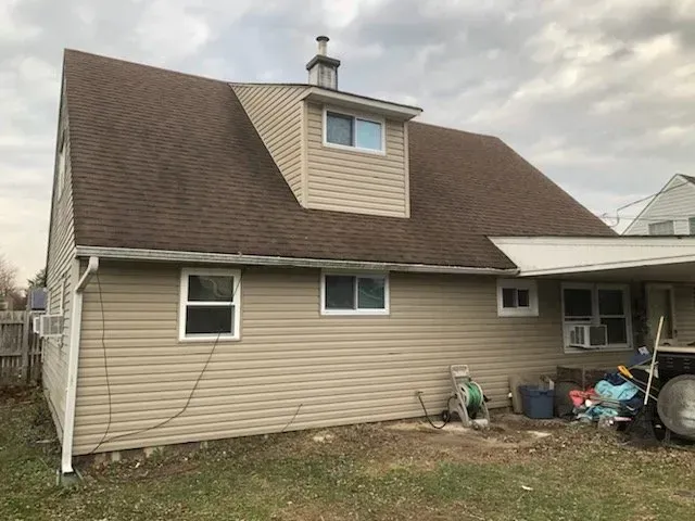 A house with a brown roof and a lot of windows