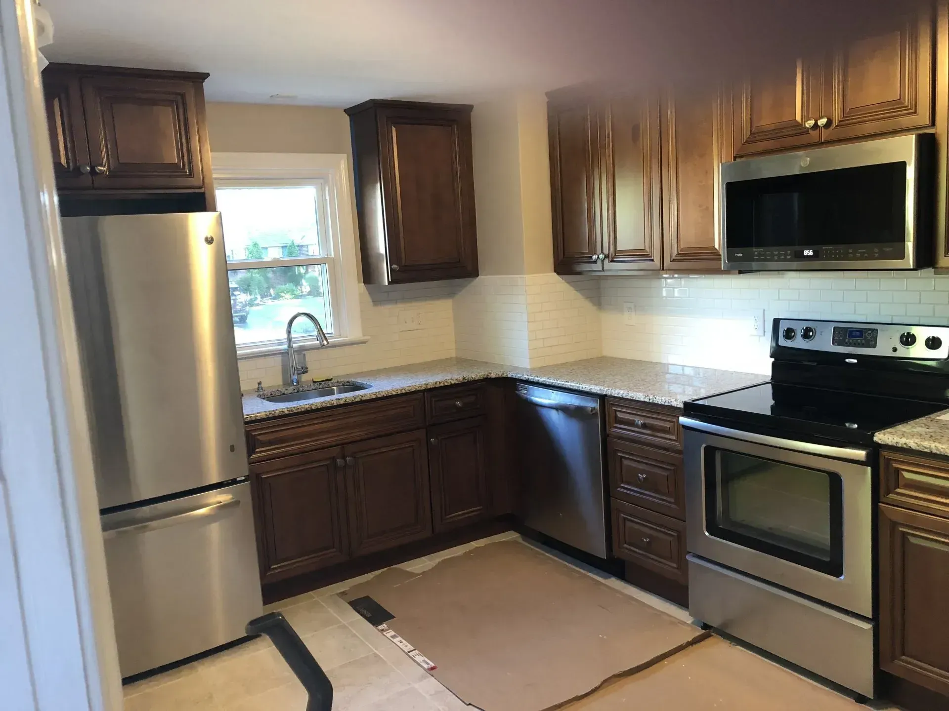 A kitchen with stainless steel appliances and wooden cabinets