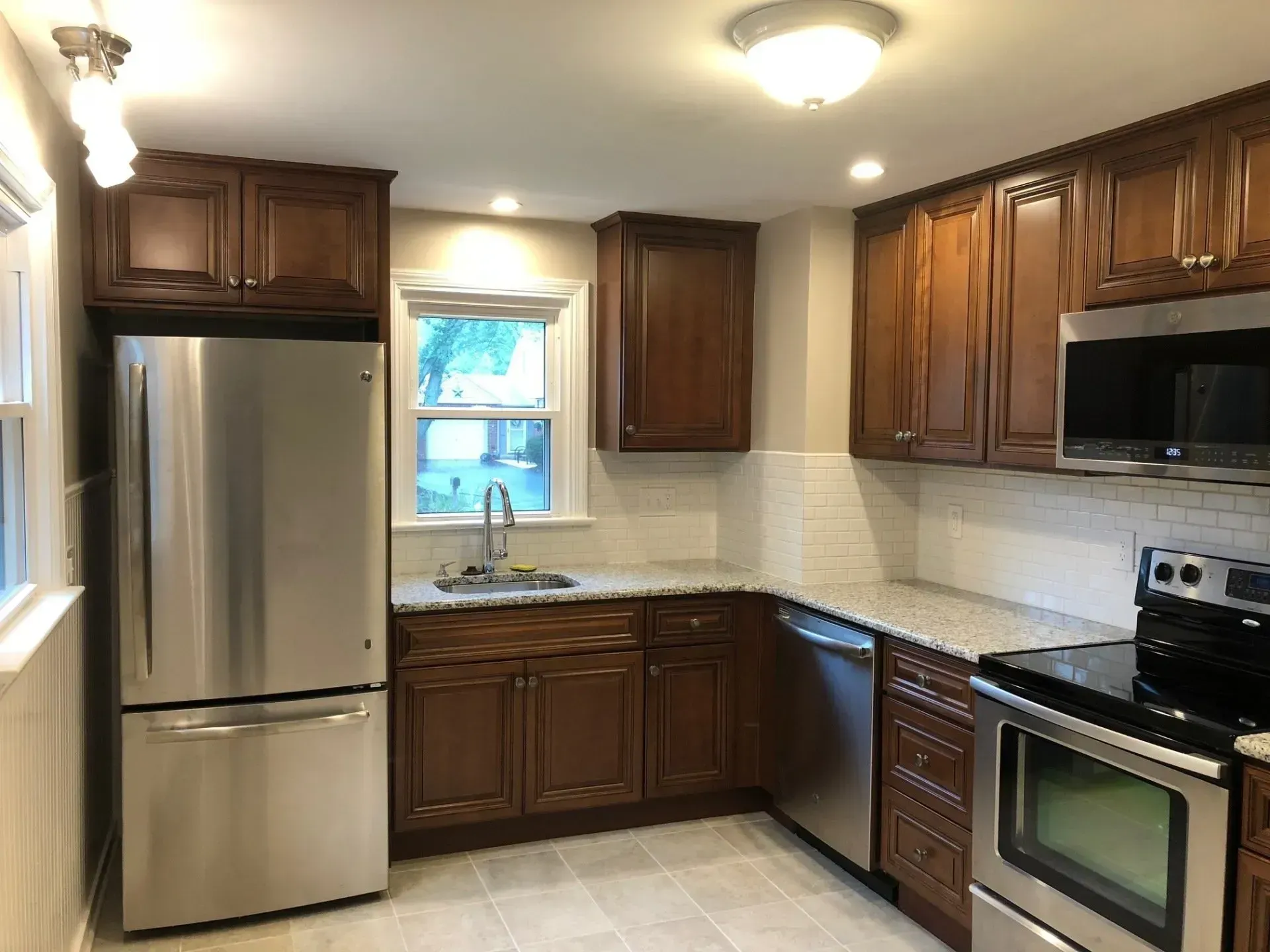 A kitchen with stainless steel appliances and wooden cabinets