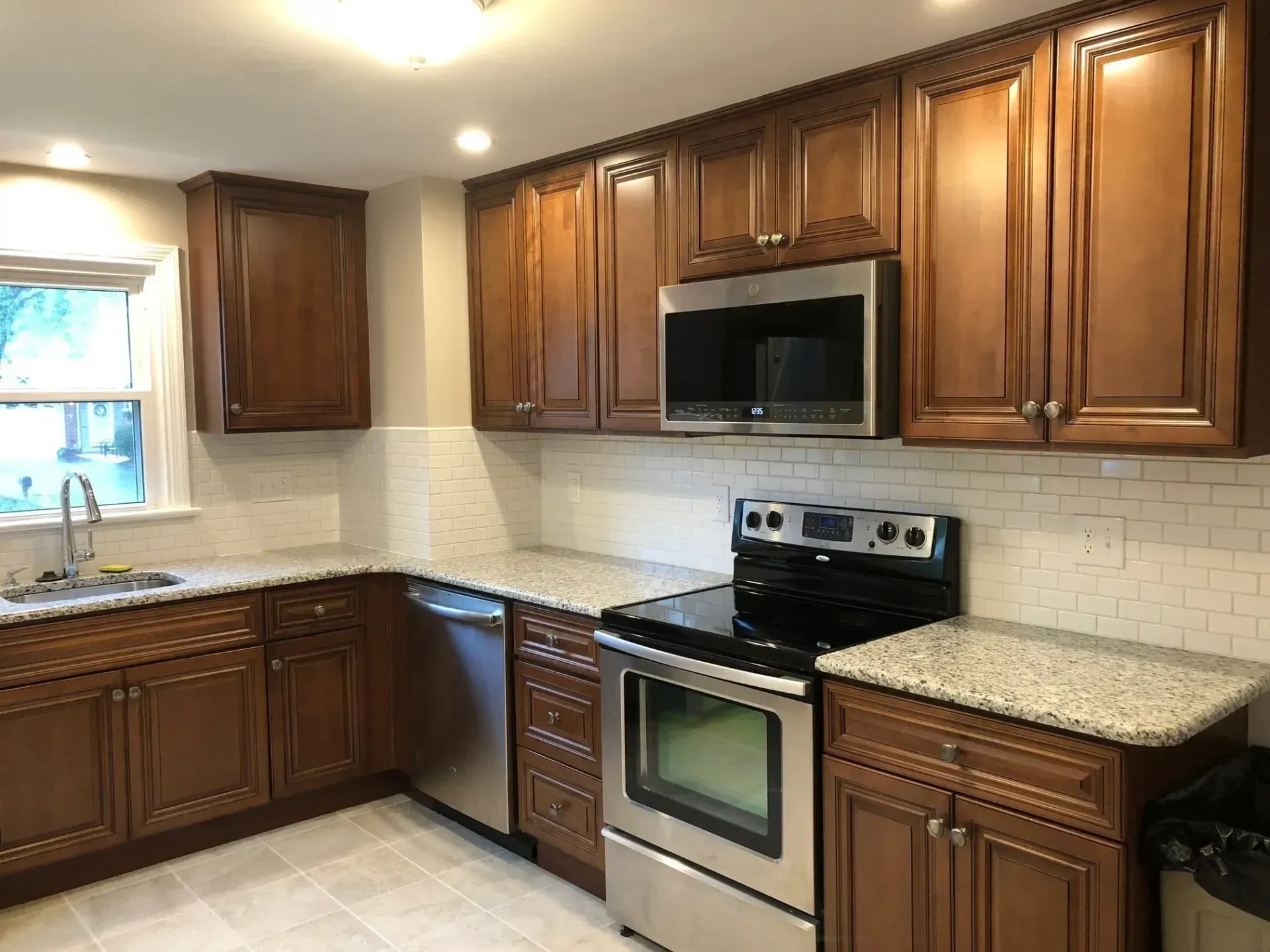 A kitchen with stainless steel appliances and wooden cabinets