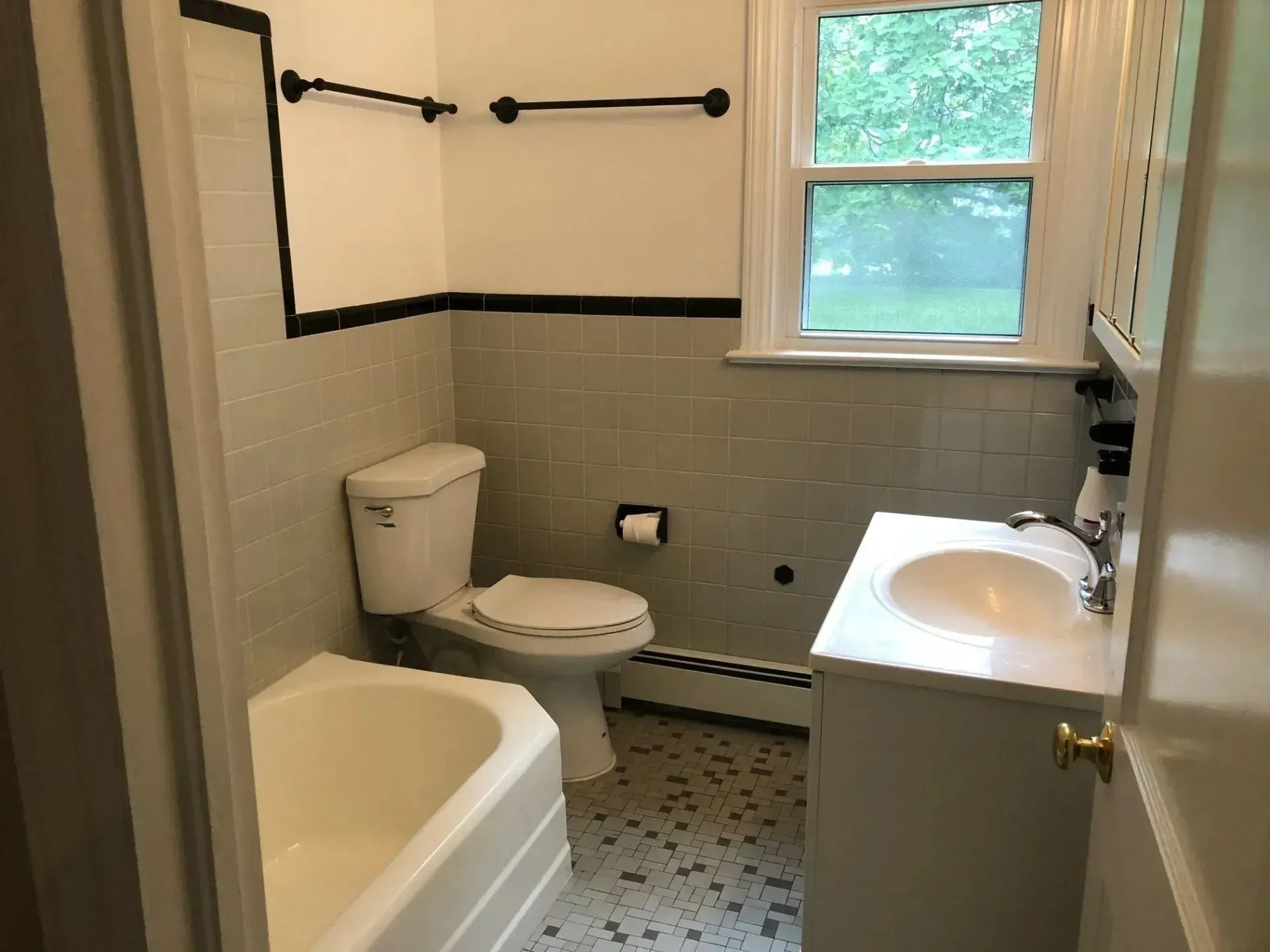 A bathroom with a toilet , sink and bathtub
