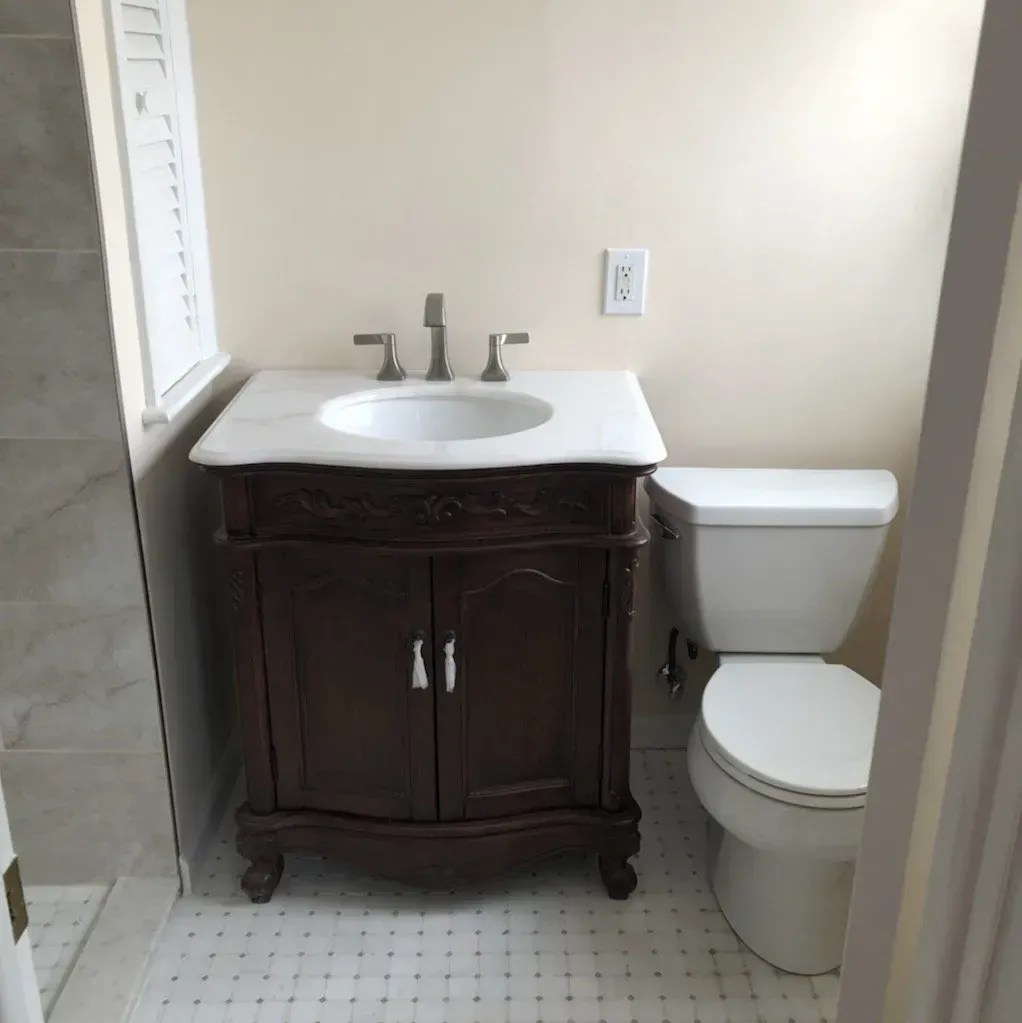 A bathroom with a sink and toilet in it