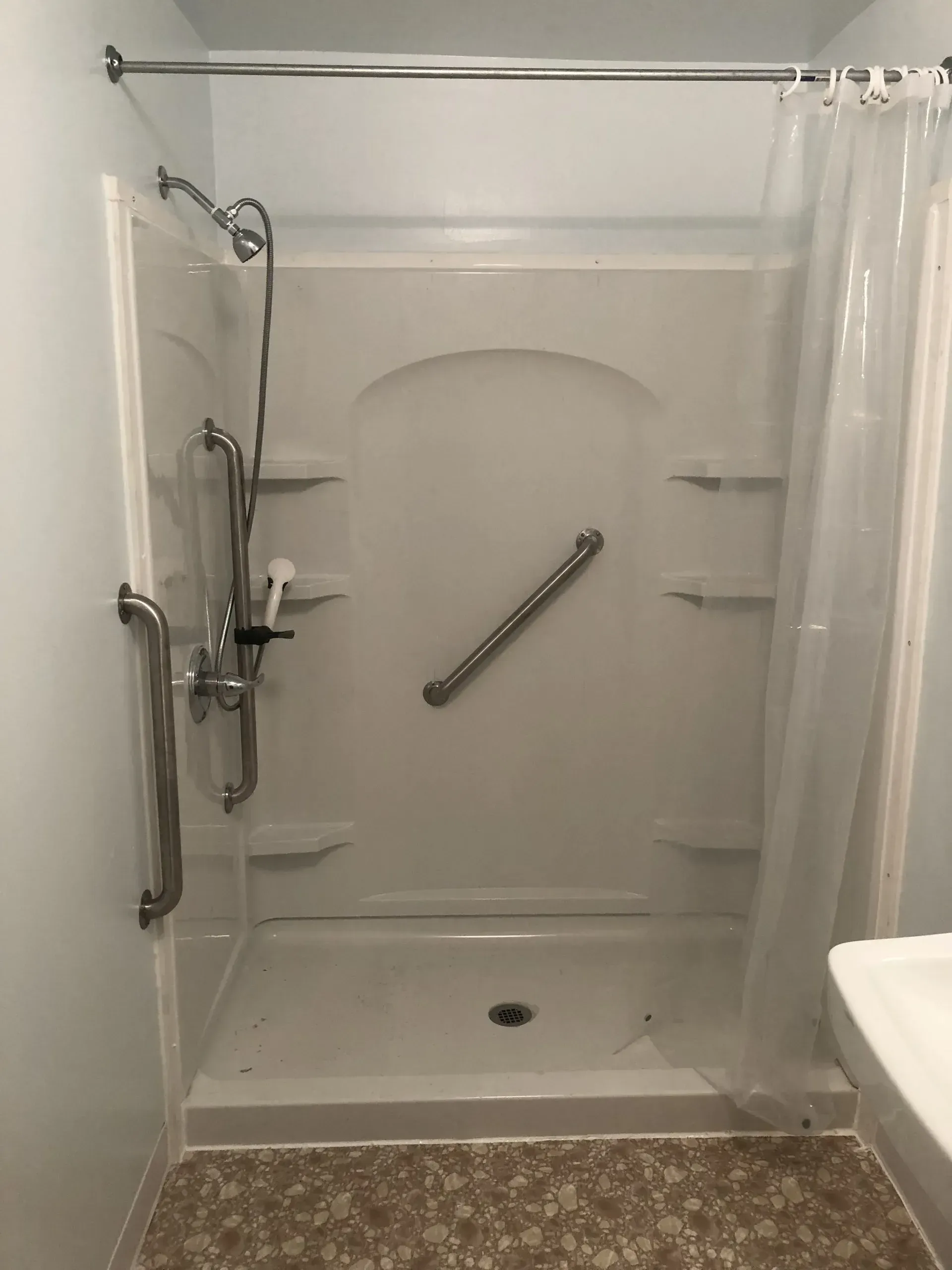 A bathroom with a walk in shower and a toilet.