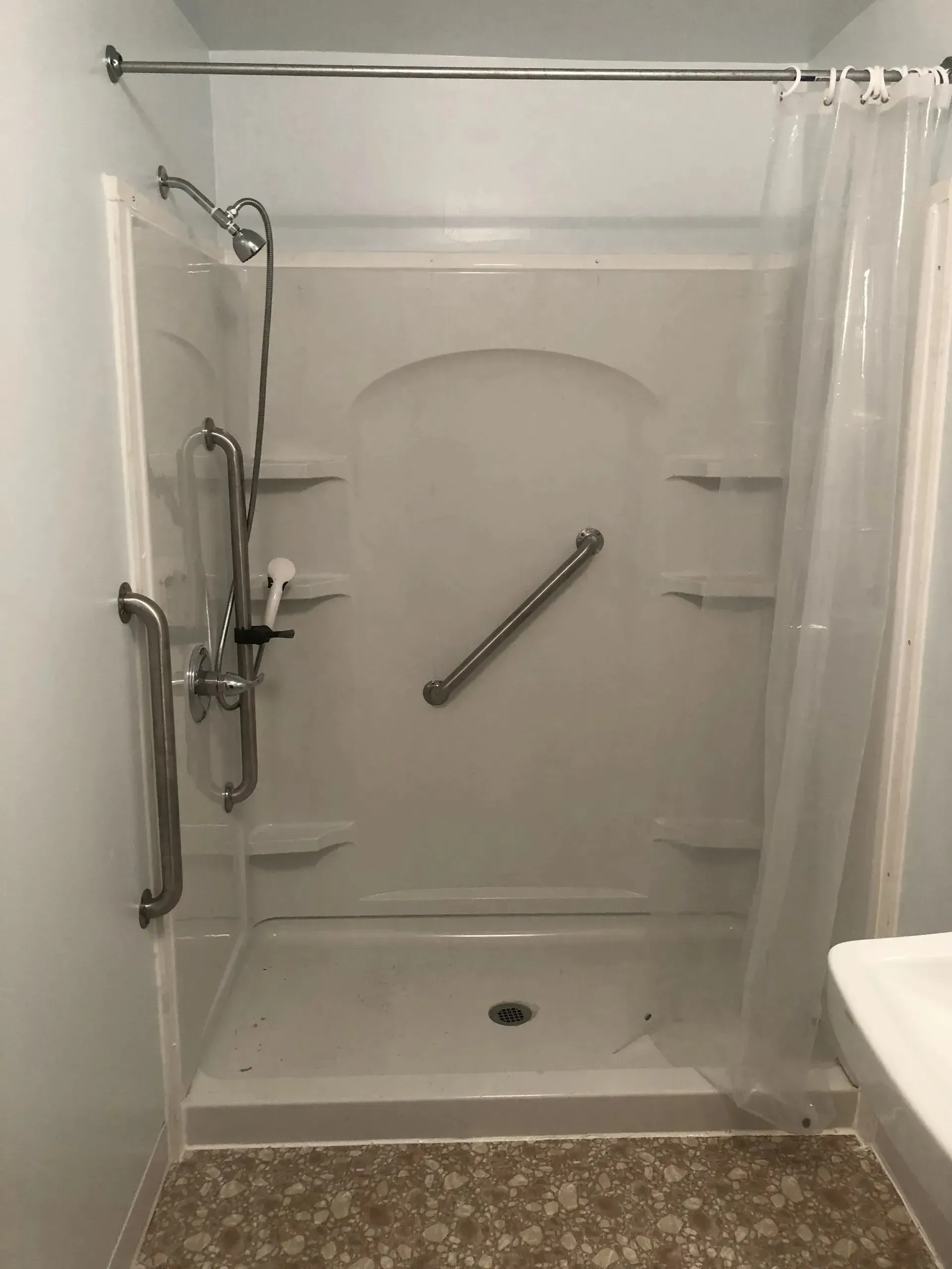 A bathroom with a walk in shower and a toilet.