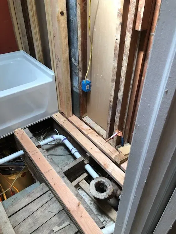 A bathroom under construction with a bathtub and a toilet.