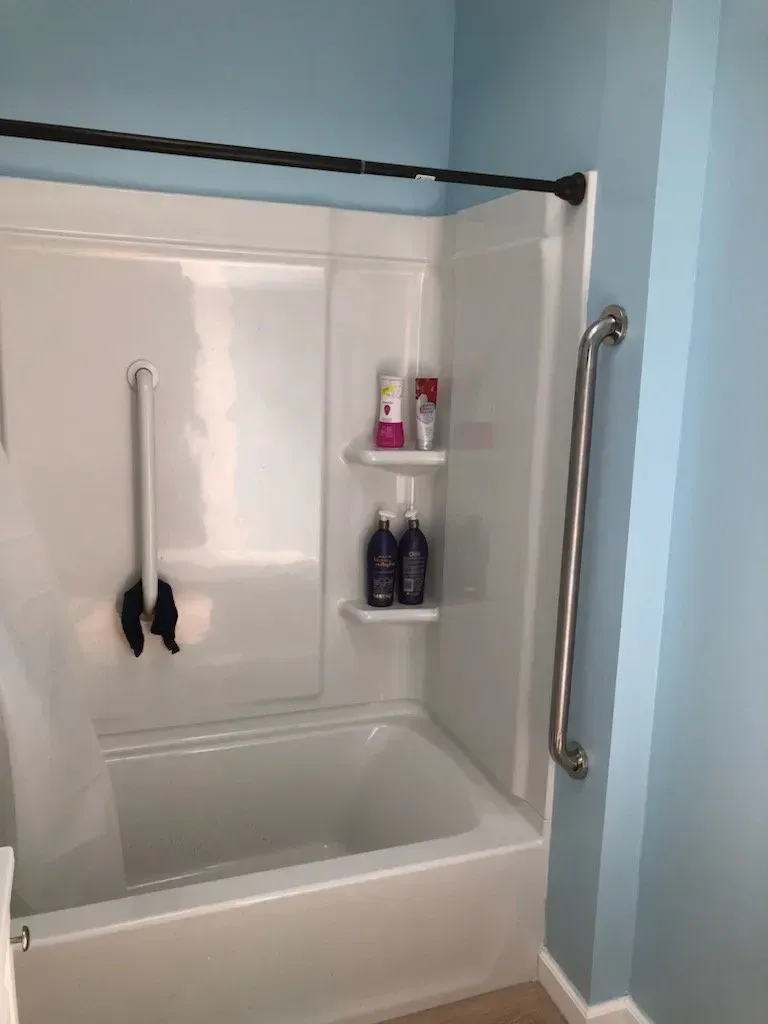 A bathroom with a bathtub and a shower stall.