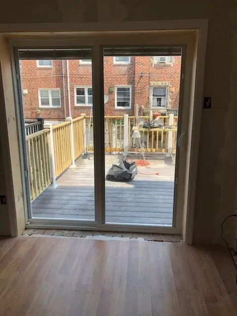 A room with a sliding glass door leading to a deck.