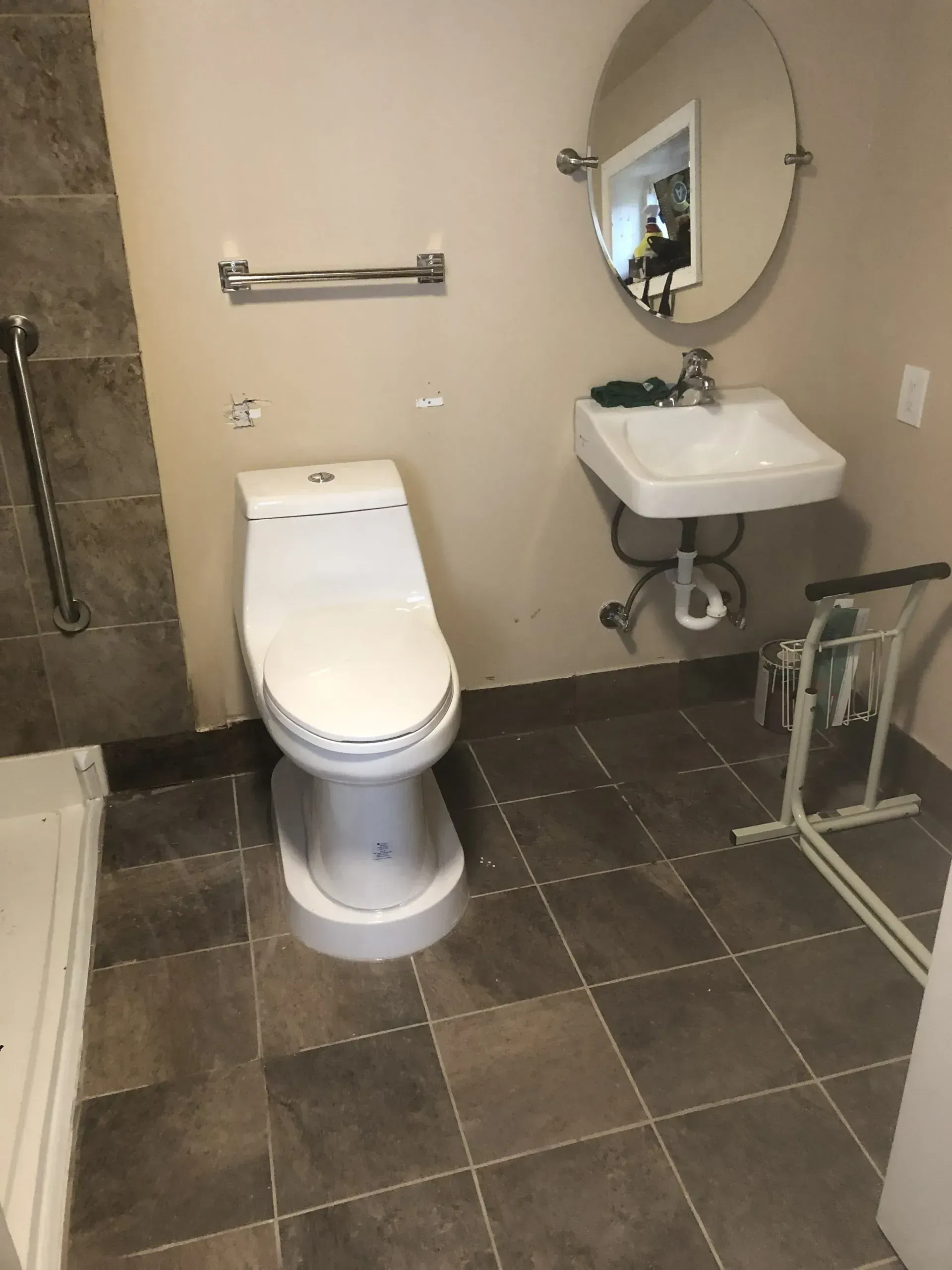 A bathroom with a toilet sink and mirror