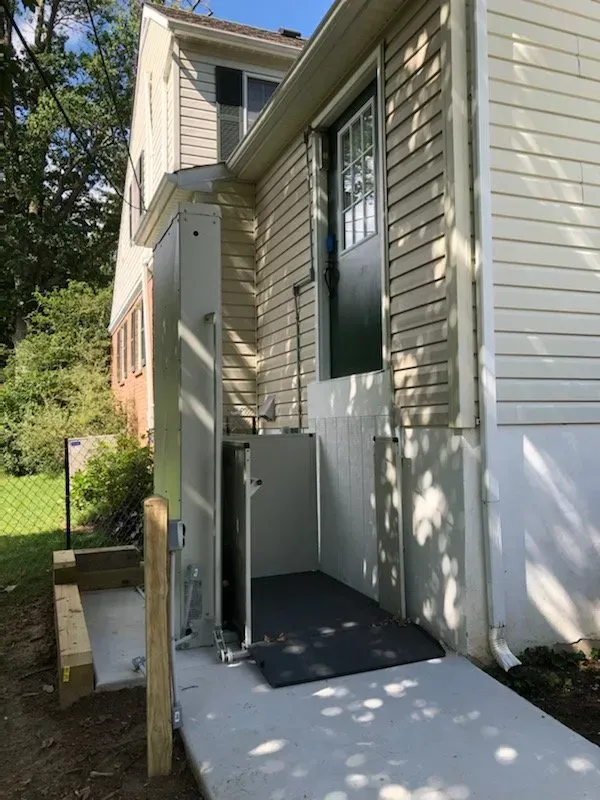 A house with a staircase leading up to the front door