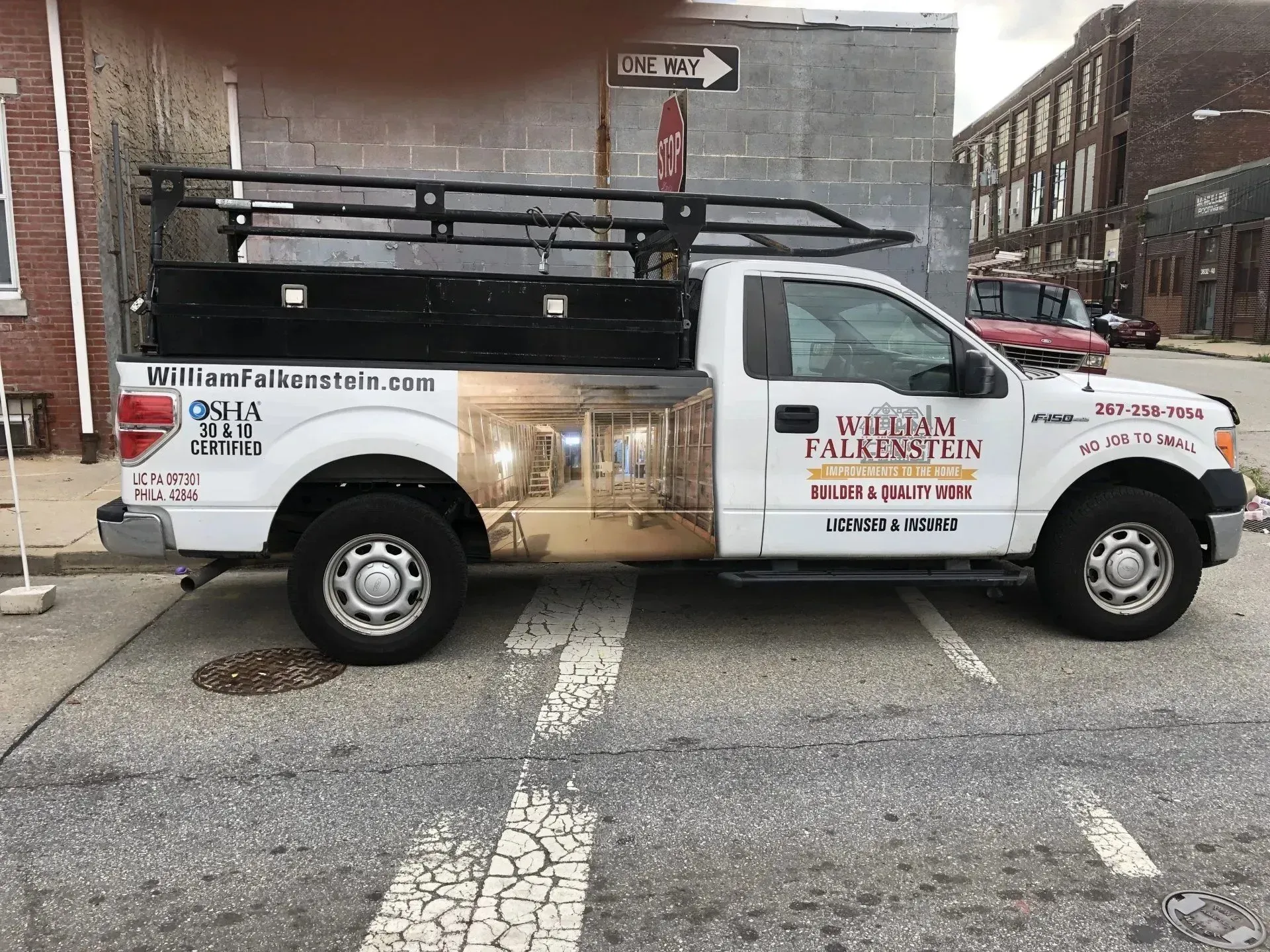 A white truck is parked on the side of the road.