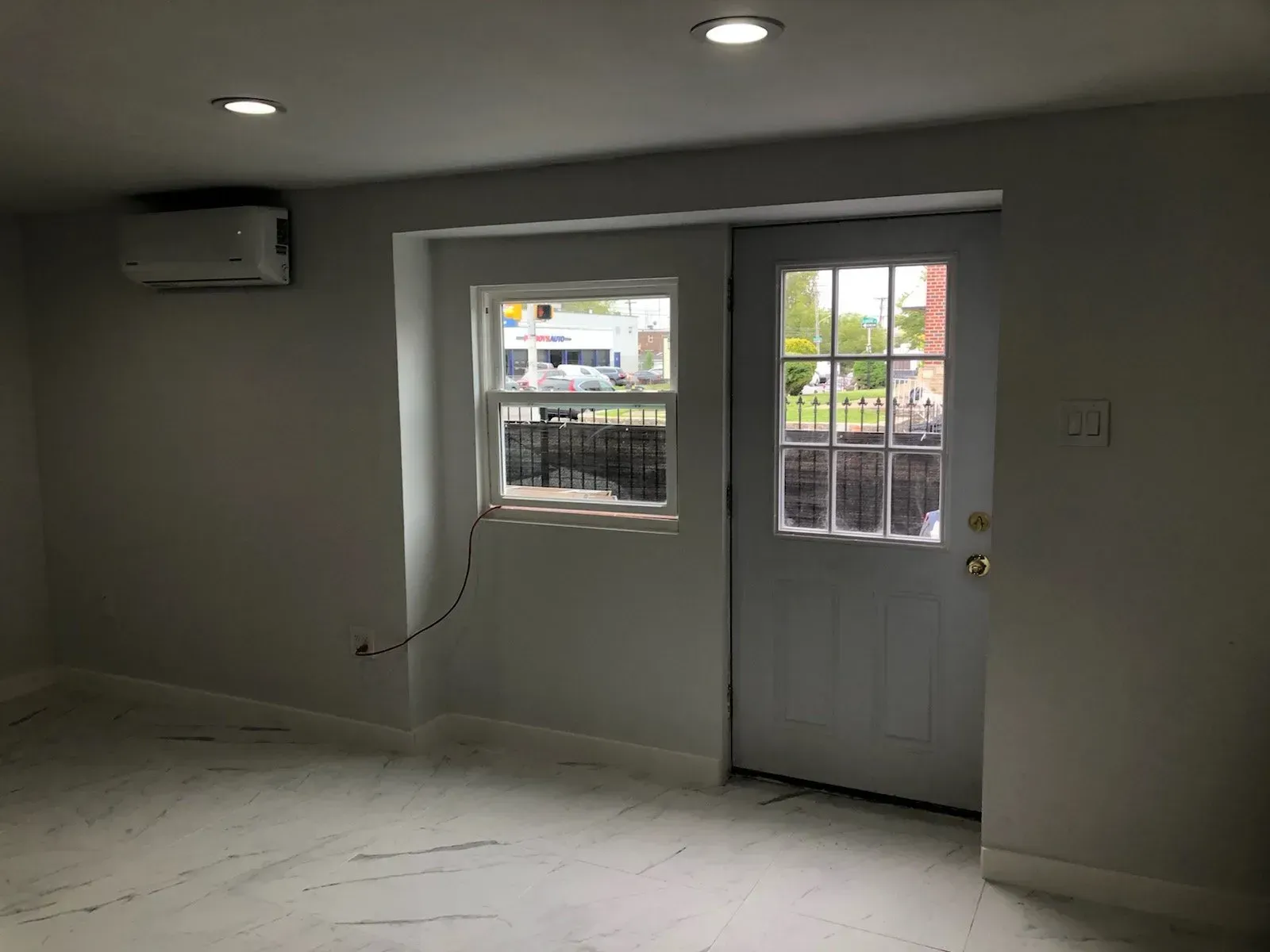 An empty room with a sliding door and a window.