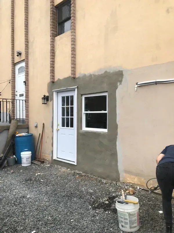 A man is painting the side of a building.