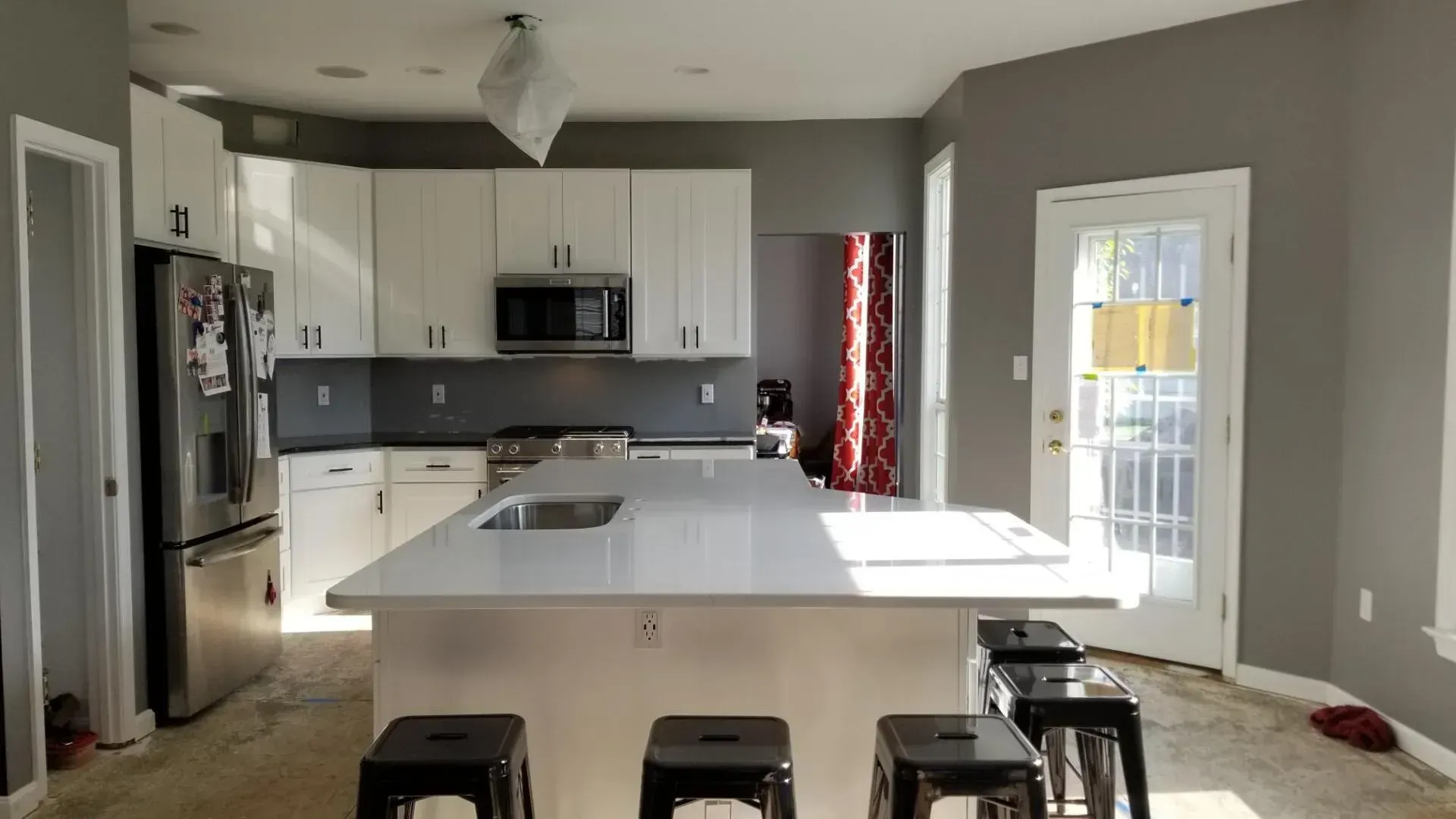 A kitchen with a large island and stools