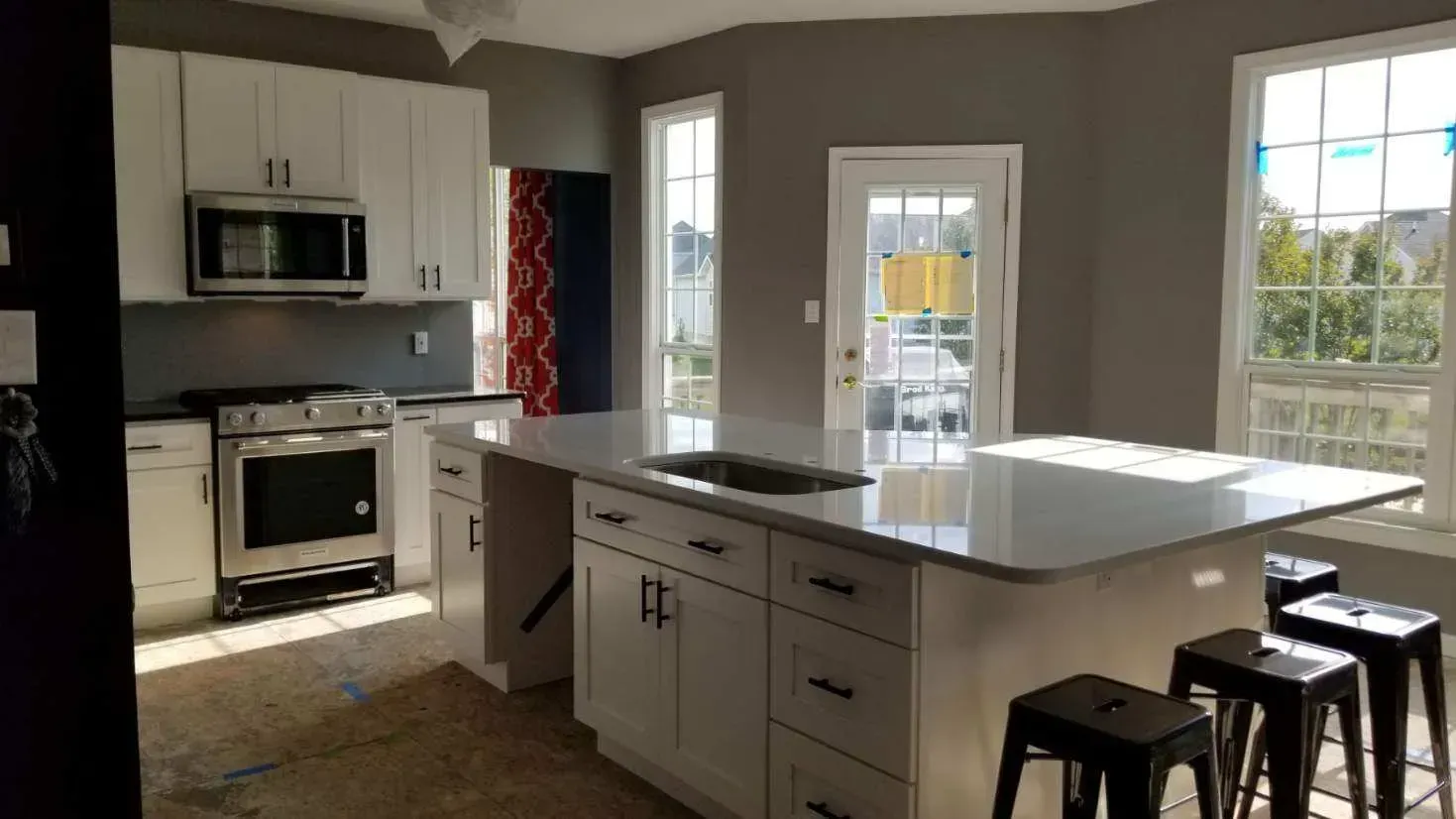 There is a large island in the middle of the kitchen.