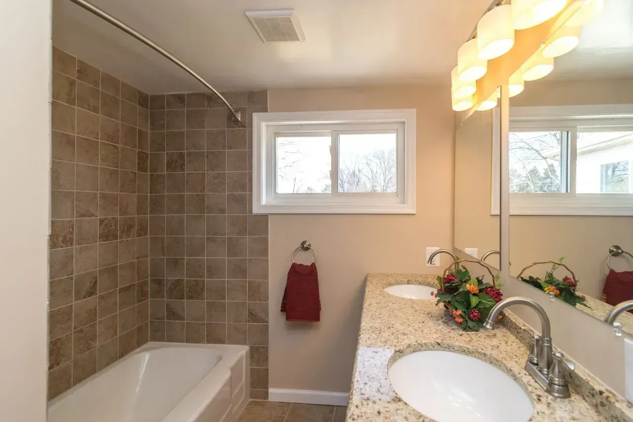 A bathroom with two sinks and a bathtub