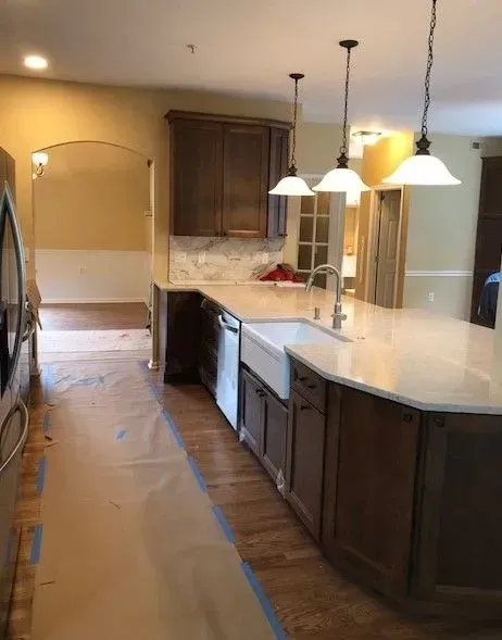 A kitchen with a large island and a sink