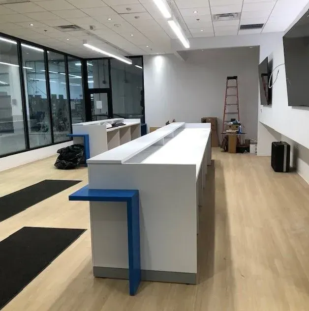 A long white counter with a blue stripe on the side of it