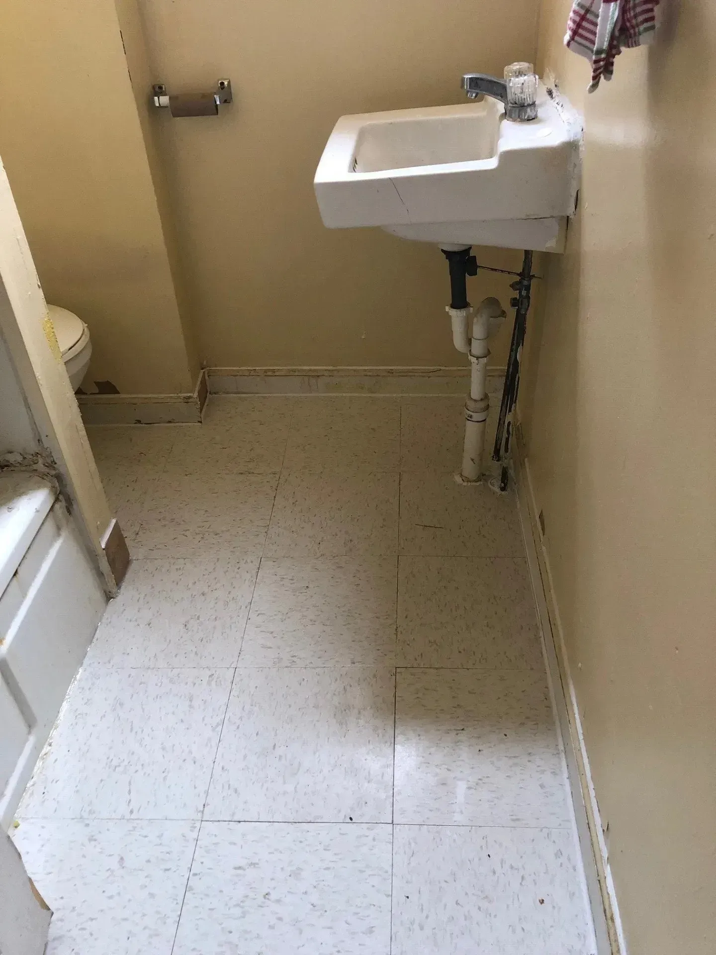 A bathroom with a sink , toilet and bathtub.