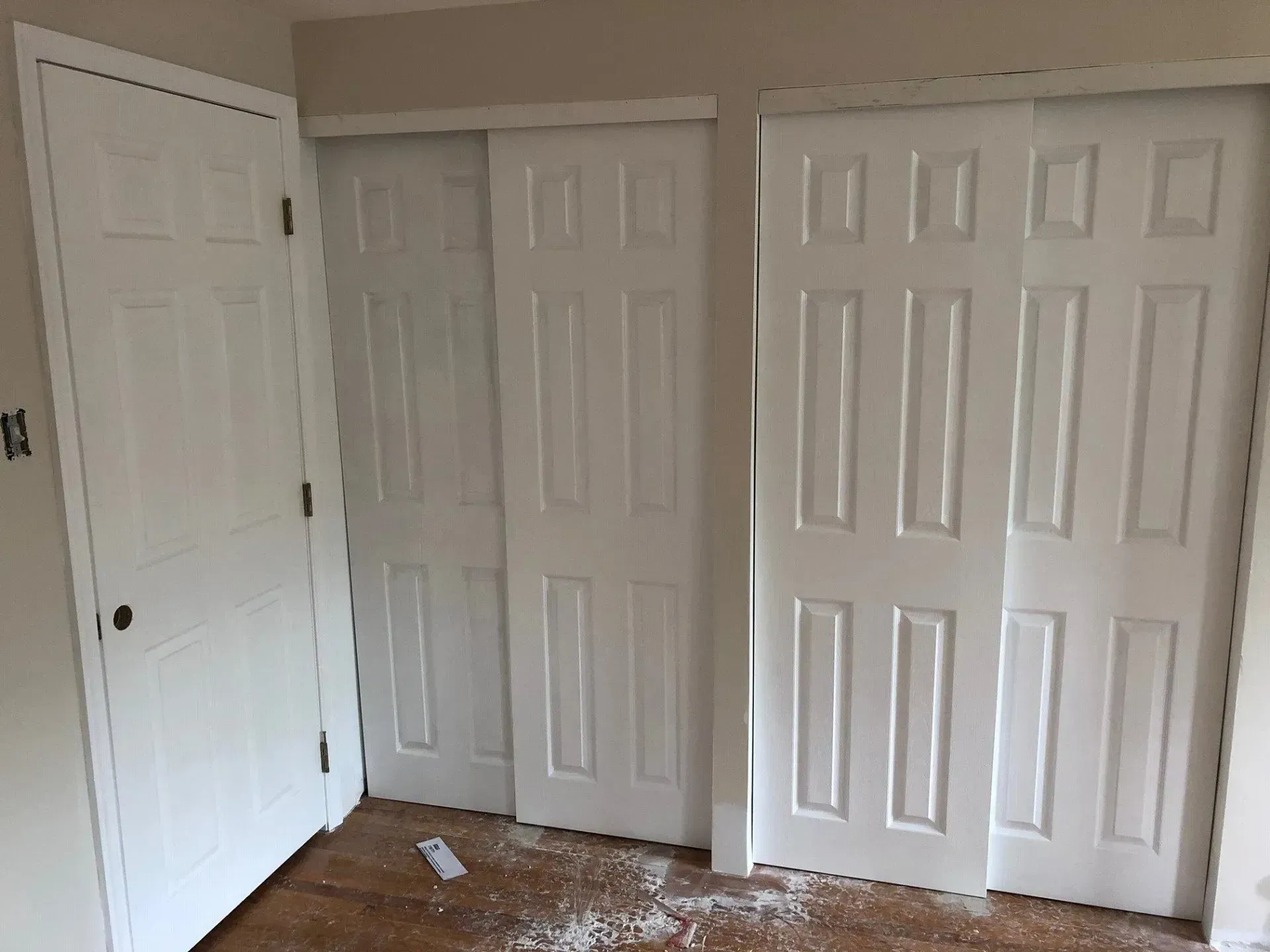 A room with a lot of white closet doors