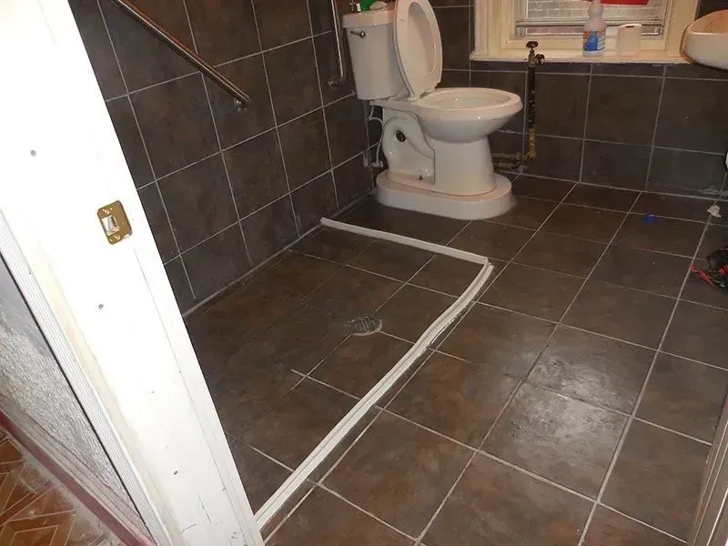 A bathroom with a toilet and a sink in it
