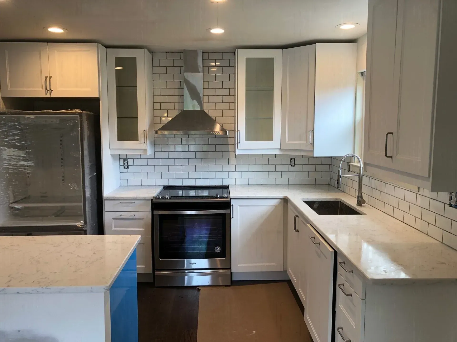 A kitchen with white cabinets and stainless steel appliances