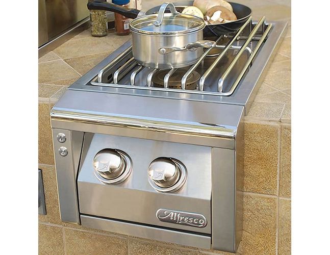 A stainless steel stove with a pot and pan on it.