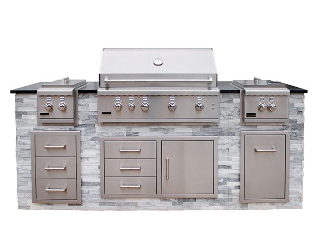 A large outdoor kitchen with a grill , cabinets , drawers and a sink.
