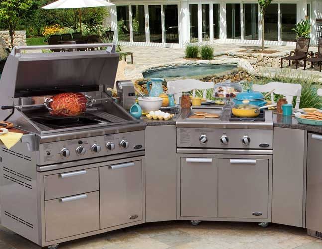 A stainless steel outdoor kitchen with a grill and a sink