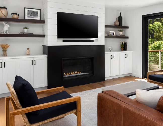 A living room with a fireplace and a flat screen tv.