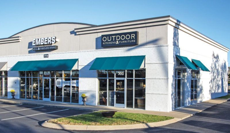 A white building with a sign that says outdoor on it