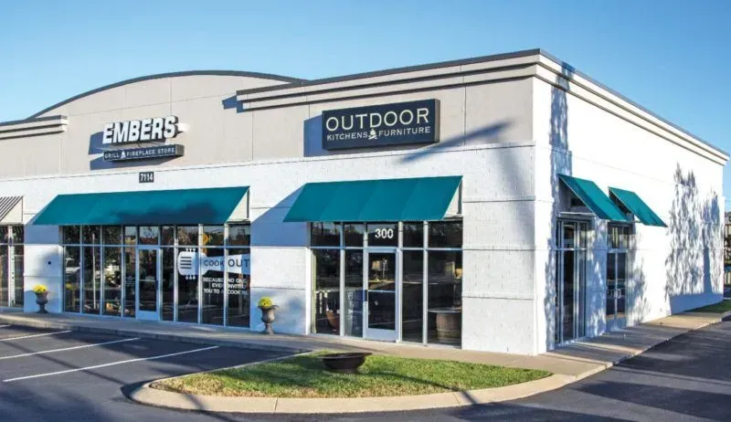 A white building with a sign that says outdoor on it