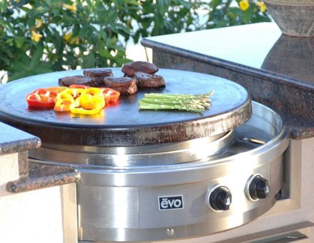 A evo grill with meat and vegetables on it