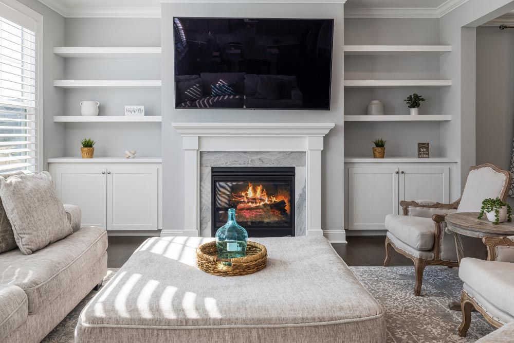 A living room with a fireplace and a flat screen tv.