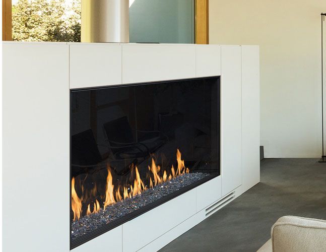 A fireplace with flames coming out of it in a living room
