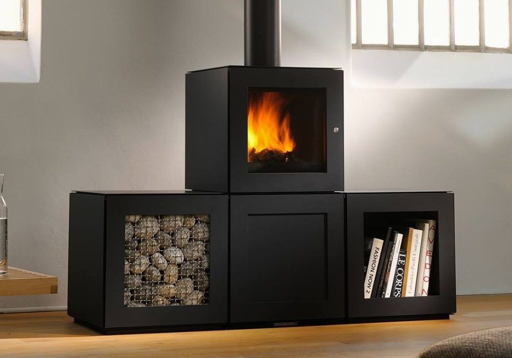 A black fireplace with a bookshelf underneath it