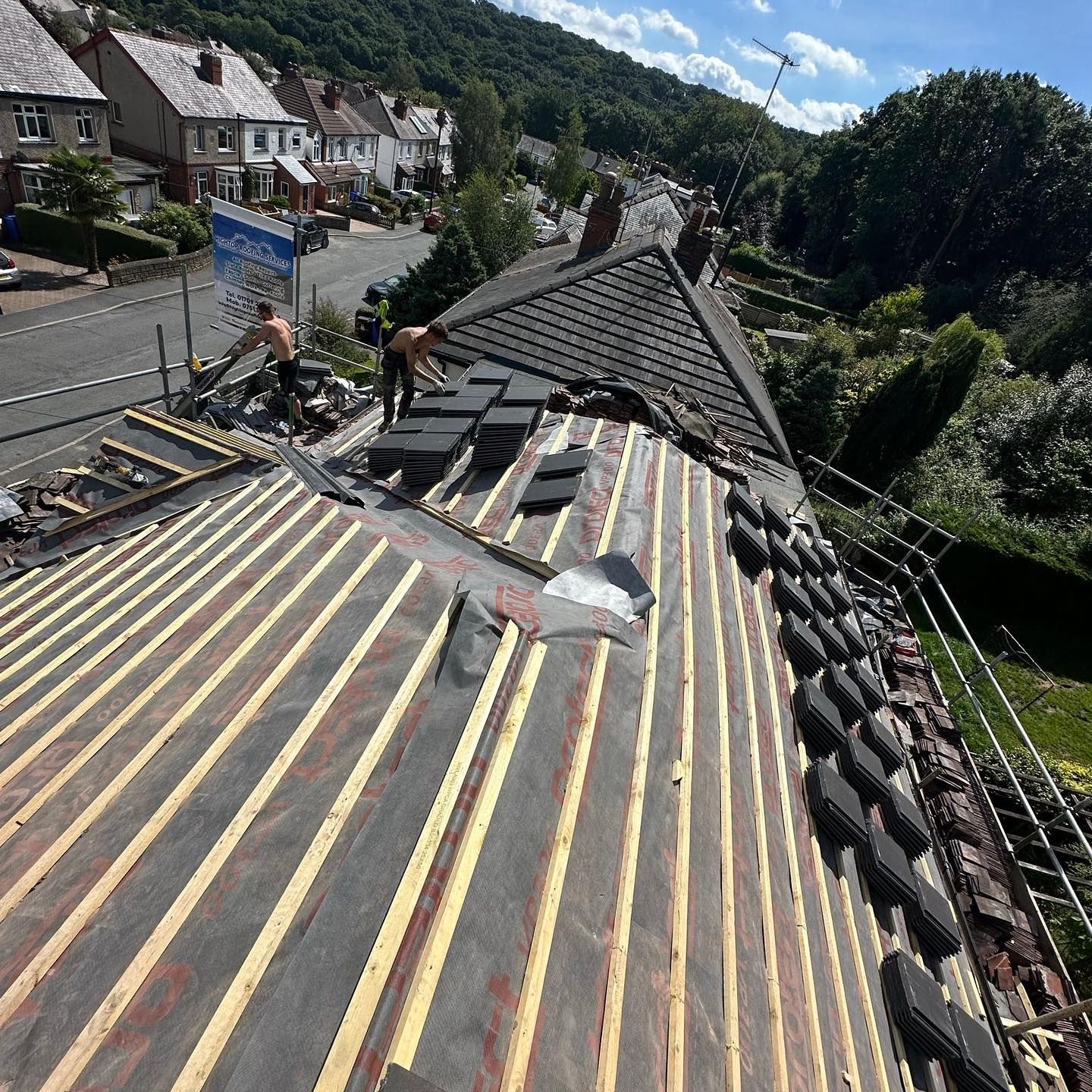 A picture of Hightop Roofers Glasgow working on a pitched roof