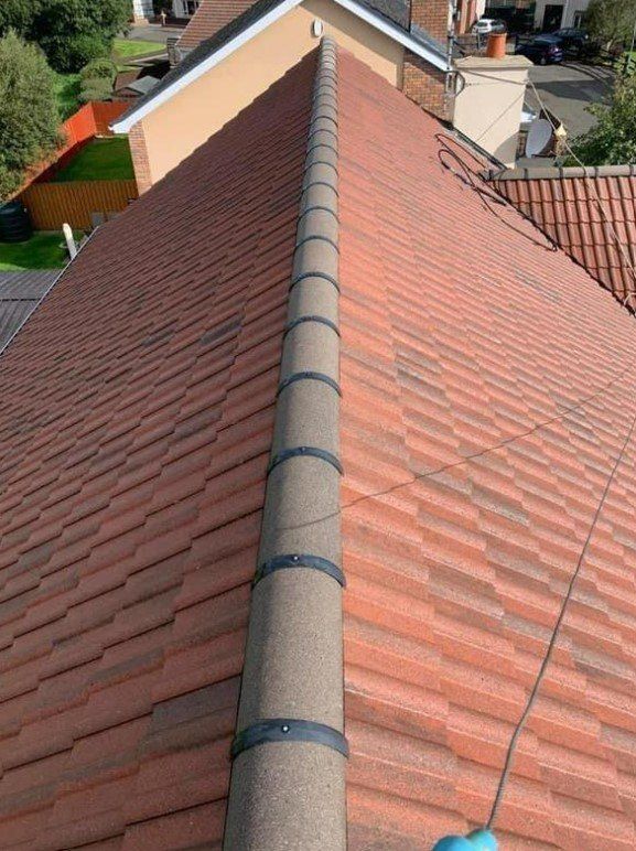 Picture of a a gable roof in dark english red tiles by Roofers Glasgow