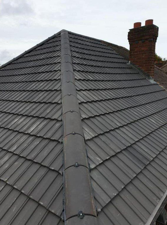 Picture of a new grey concrete tile hipped roof by roofers Glasgow