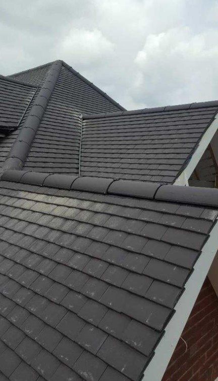 picture of a new roof replacement with dark grey plain concrete tiles by Roofers Glasgow