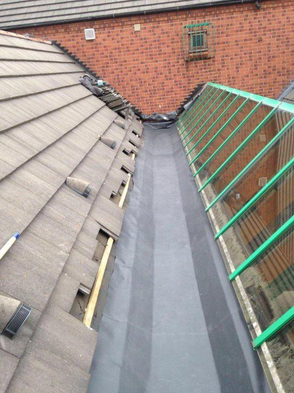 Picture of a gutter lined in lead substitute by Roofers Glasgow