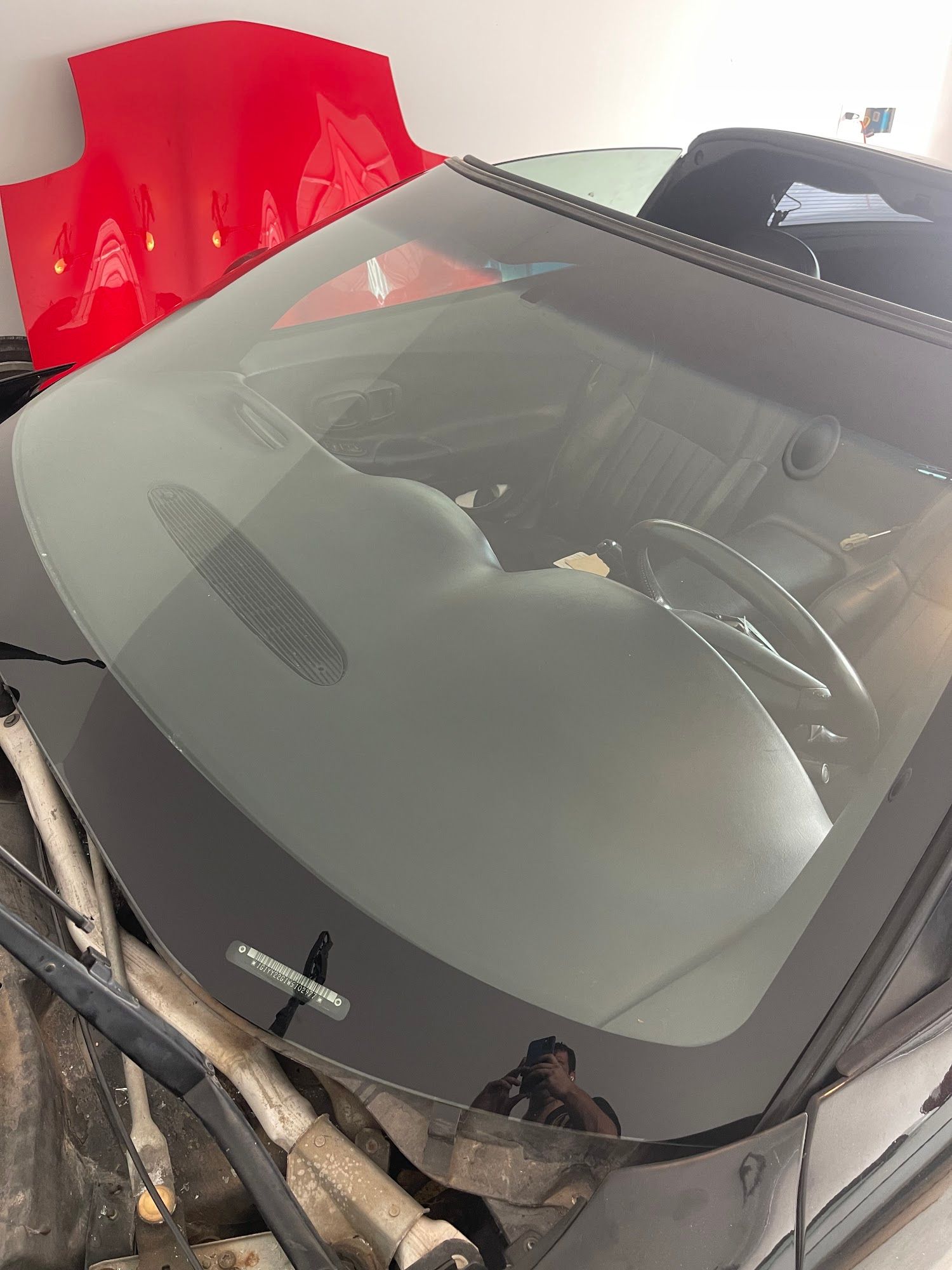 A close up of a car windshield in a garage.
