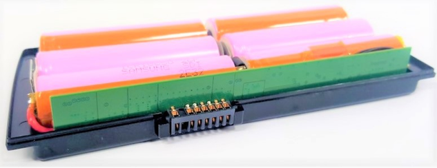 Battery pack with orange, pink, and green cylindrical cells arranged in a black plastic tray.