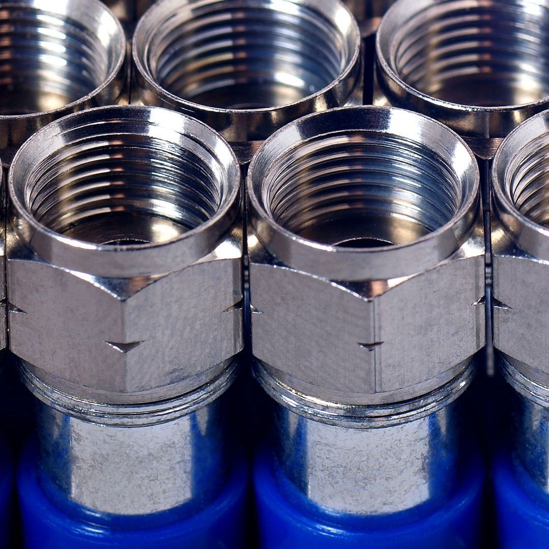 A bunch of metal connectors are lined up in a row